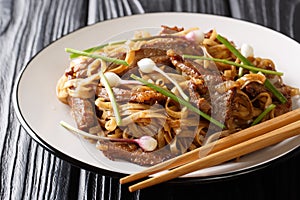 Beef chow funÂ is a staple Cantonese dish, made from stir-frying beef, hor fun wide rice noodles and bean sprouts closeup.